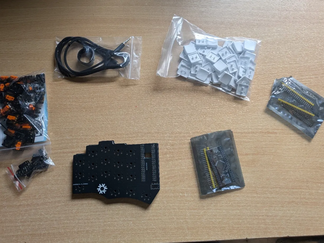 Keyboard parts laid out: switches, microcontroller, TRRS cable